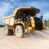 Water powered dust suppression for dumpers