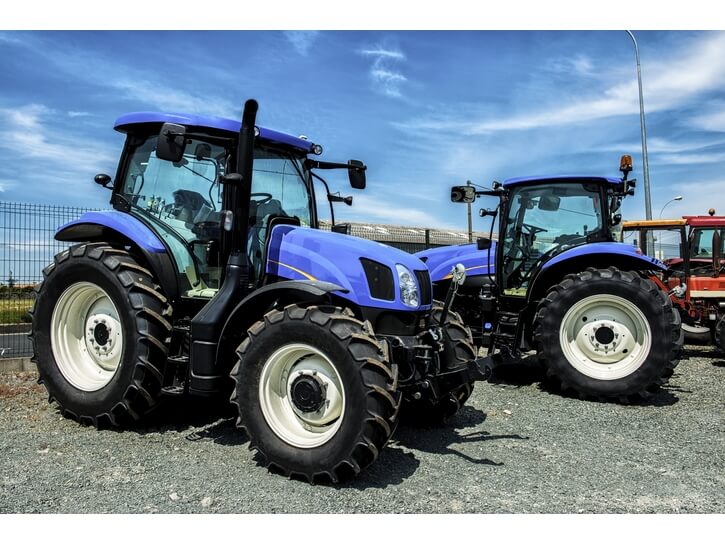 2 blue farm tractors